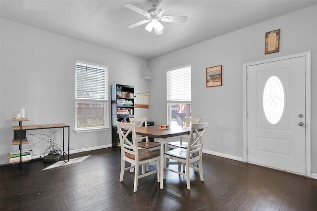 dining room featuring a ceiling fan, wood finished floors, and baseboards