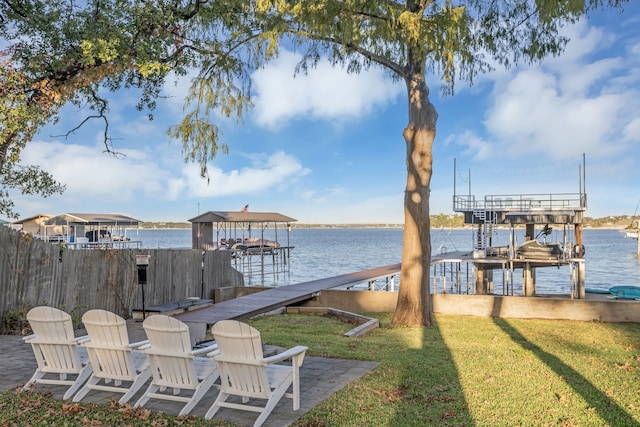 view of dock with a lawn, a water view, and boat lift