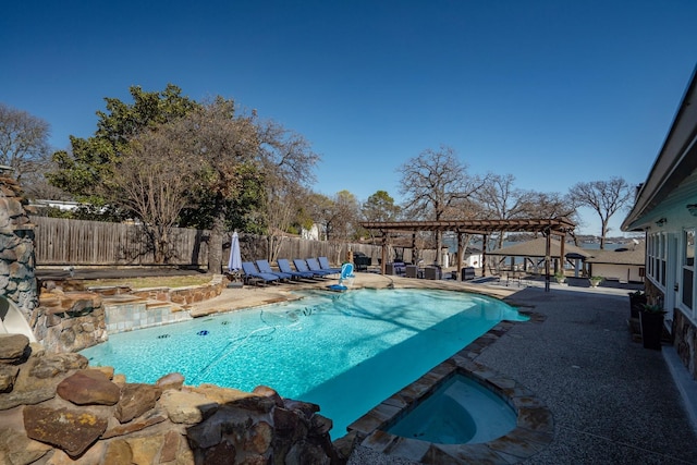 view of swimming pool with a fenced backyard, an in ground hot tub, a pergola, and a patio