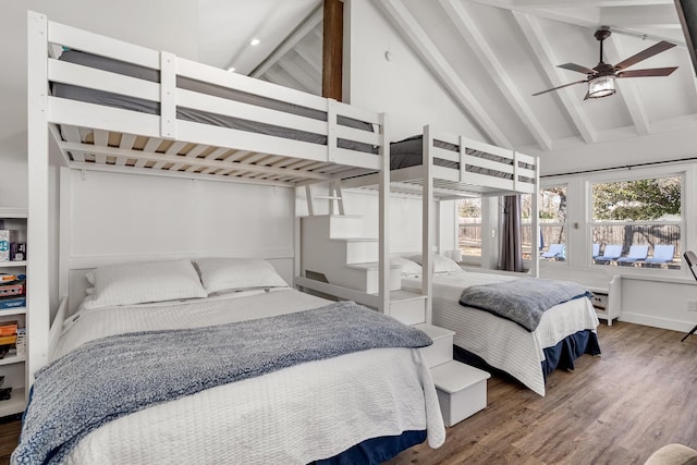 bedroom featuring beamed ceiling, wood finished floors, and high vaulted ceiling