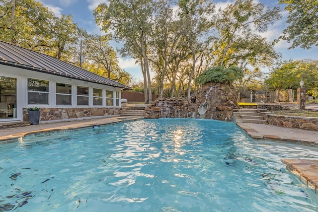 view of swimming pool featuring fence and a fenced in pool