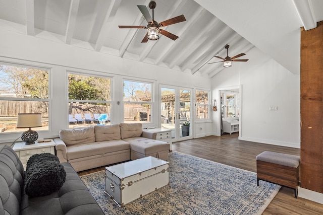 living room featuring beam ceiling, wood finished floors, baseboards, and high vaulted ceiling