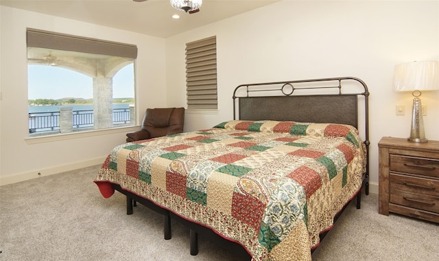 bedroom with recessed lighting, baseboards, a water view, and carpet floors