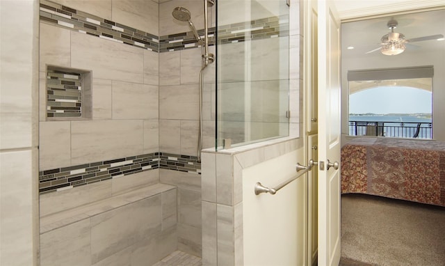 bathroom with a ceiling fan, a tile shower, and connected bathroom