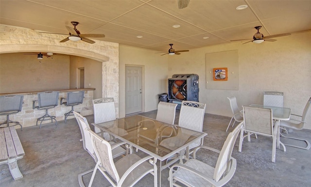 view of patio featuring outdoor dining space and a ceiling fan