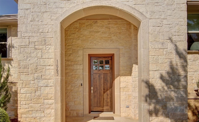 entrance to property with stone siding