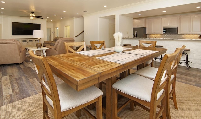 dining area with recessed lighting, dark wood-type flooring, a ceiling fan, and ornamental molding