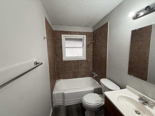 full bath with vanity, wood finished floors, a textured ceiling, toilet, and shower / bathtub combination