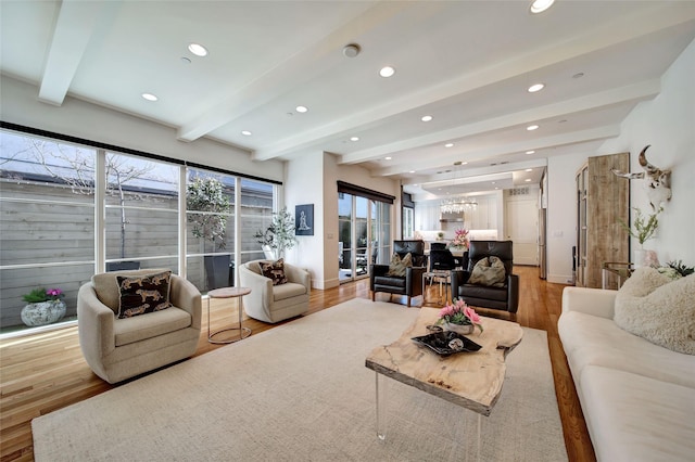 living room with beam ceiling, recessed lighting, and light wood-style floors