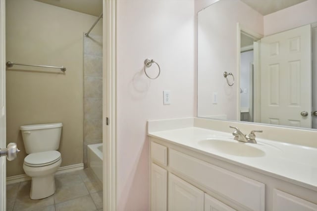 bathroom featuring toilet, shower / tub combination, tile patterned flooring, baseboards, and vanity