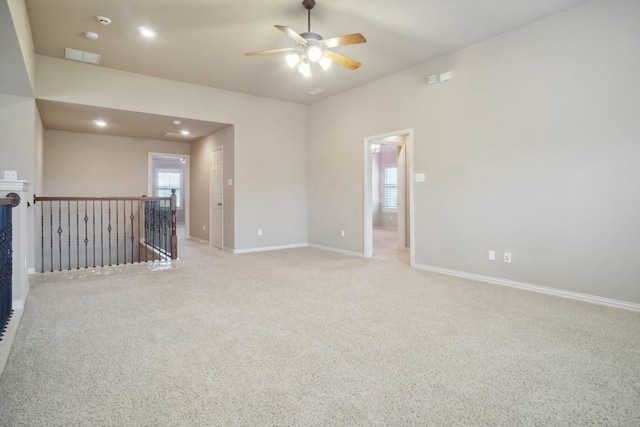 carpeted empty room featuring a ceiling fan, visible vents, recessed lighting, and baseboards