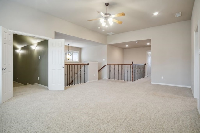 spare room featuring visible vents, baseboards, and light colored carpet