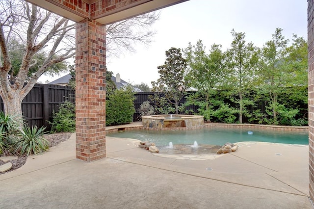 view of swimming pool with an in ground hot tub, a fenced backyard, and a patio