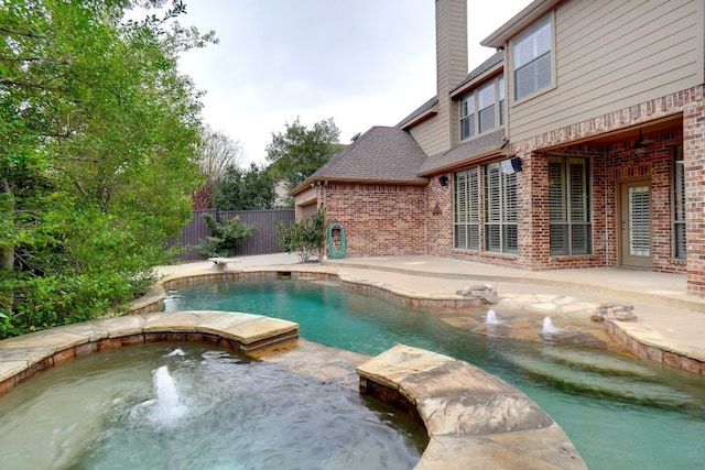 view of pool with a fenced in pool, fence, an in ground hot tub, a diving board, and a patio area