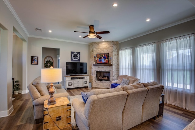 living room featuring wood finished floors, visible vents, and ornamental molding