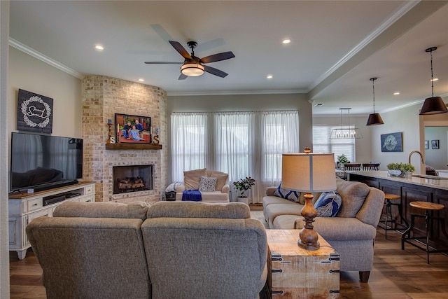 living area featuring a wealth of natural light and crown molding