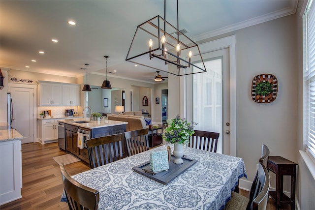 dining room featuring a wealth of natural light, ornamental molding, dark wood finished floors, recessed lighting, and ceiling fan