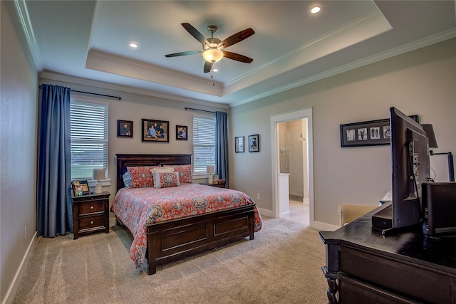 bedroom with a tray ceiling, crown molding, baseboards, and light carpet