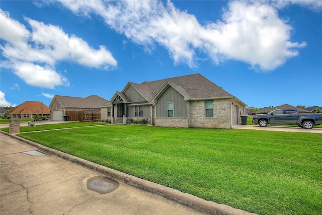 ranch-style house with driveway, a front lawn, board and batten siding, an attached garage, and brick siding