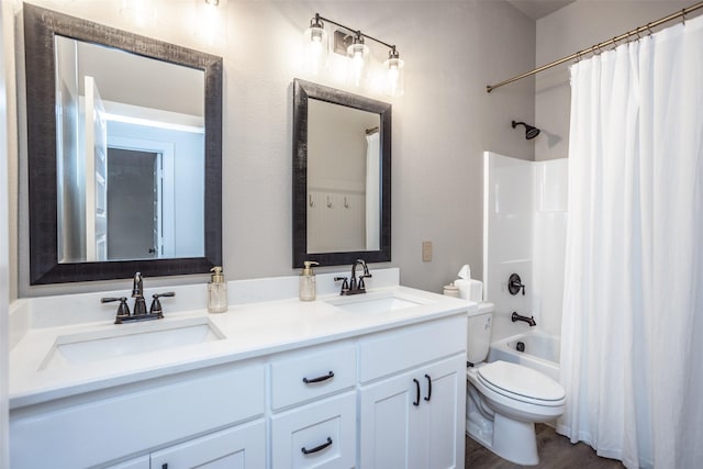 bathroom with double vanity, toilet, shower / bath combo with shower curtain, and a sink