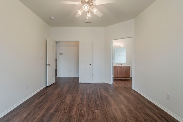 unfurnished bedroom with dark wood-style floors, visible vents, a ceiling fan, and baseboards