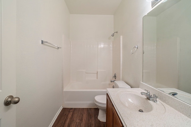 bathroom featuring baseboards, toilet, shower / bath combination, wood finished floors, and vanity