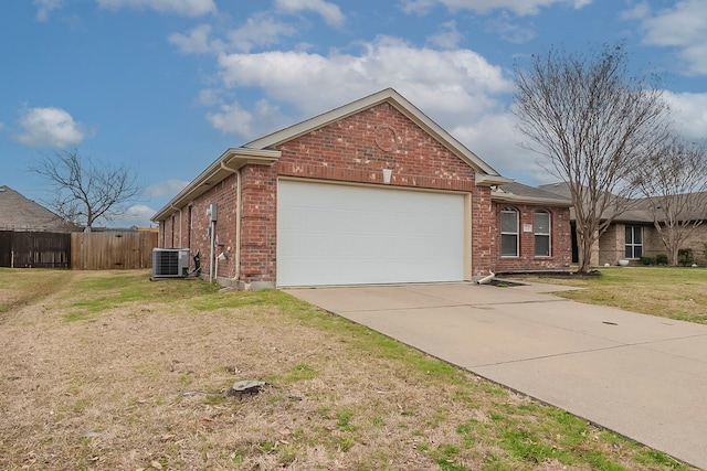 view of front of home featuring brick siding, fence, a front yard, a garage, and driveway