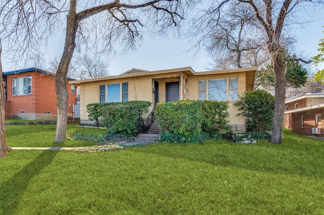 view of front of house with brick siding and a front yard