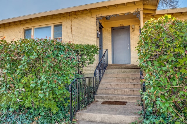 entrance to property with brick siding