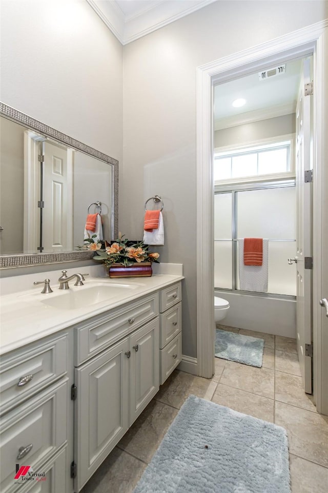 full bathroom featuring vanity, visible vents, enclosed tub / shower combo, crown molding, and toilet