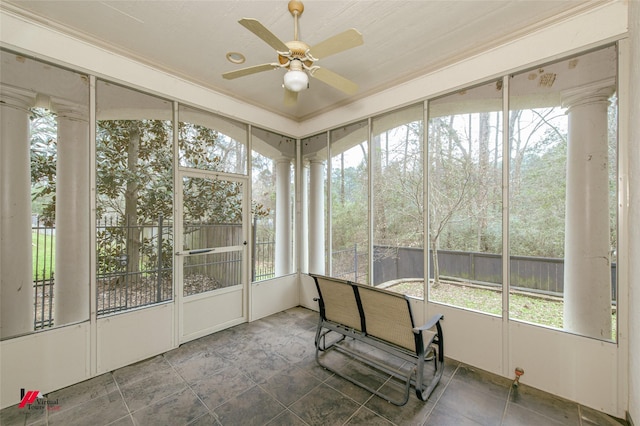 unfurnished sunroom featuring a ceiling fan