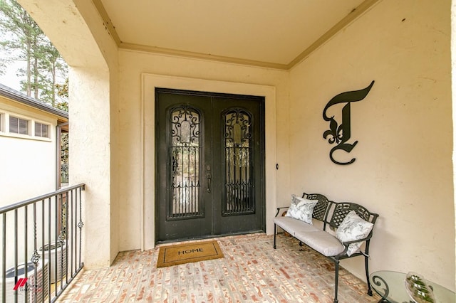 entrance to property featuring stucco siding