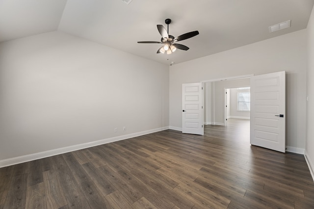 unfurnished room featuring dark wood-style floors, baseboards, visible vents, ceiling fan, and vaulted ceiling