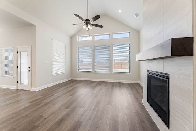 unfurnished living room featuring visible vents, baseboards, wood finished floors, and a fireplace