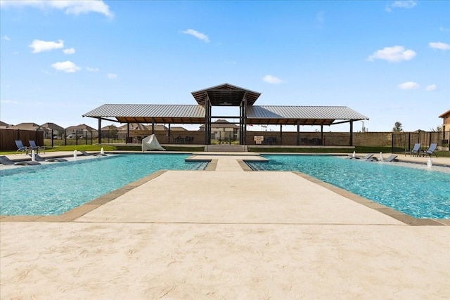 view of swimming pool with a fenced in pool, a patio, and fence