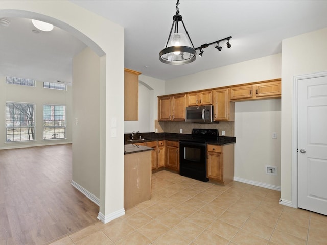 kitchen with stainless steel microwave, dark countertops, black electric range oven, and visible vents