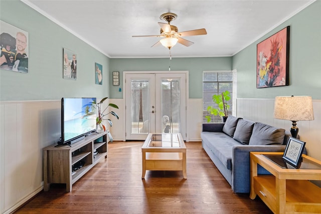 living room featuring french doors, wood finished floors, wainscoting, and crown molding