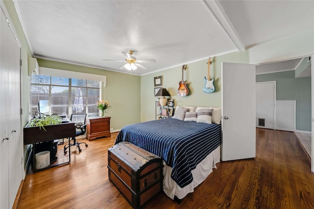 bedroom with ceiling fan, baseboards, wood finished floors, and crown molding