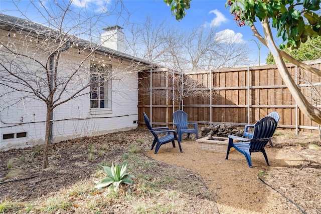 view of yard featuring fence and a fire pit