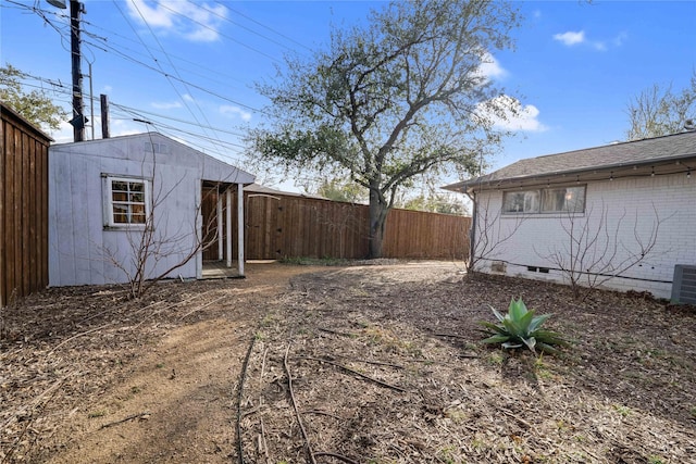 view of yard with an outbuilding and a fenced backyard