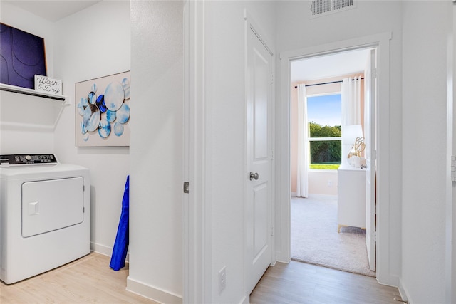 washroom with baseboards, visible vents, laundry area, light wood-style flooring, and washer / clothes dryer