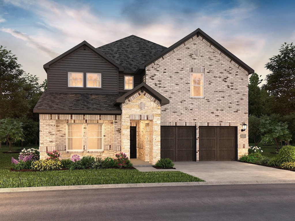 view of front of home with a garage, stone siding, brick siding, and driveway