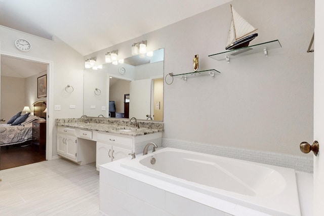 full bathroom featuring double vanity, a sink, vaulted ceiling, ensuite bathroom, and a garden tub