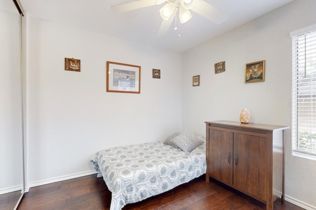 bedroom featuring a ceiling fan, baseboards, and hardwood / wood-style flooring