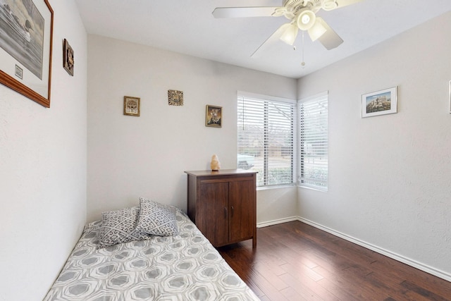 bedroom featuring baseboards, dark wood-style floors, and a ceiling fan