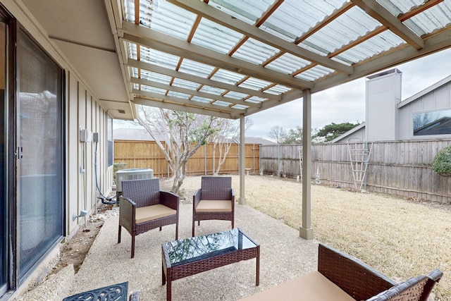 view of patio / terrace with a fenced backyard, a pergola, and central AC