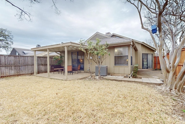 rear view of house with a patio area, a fenced backyard, cooling unit, and board and batten siding