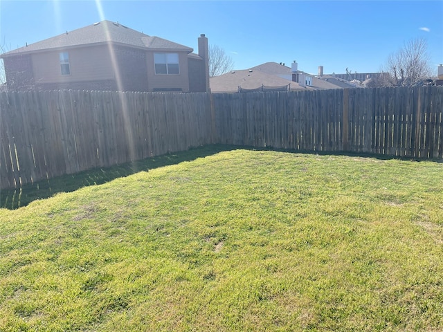 view of yard with a fenced backyard