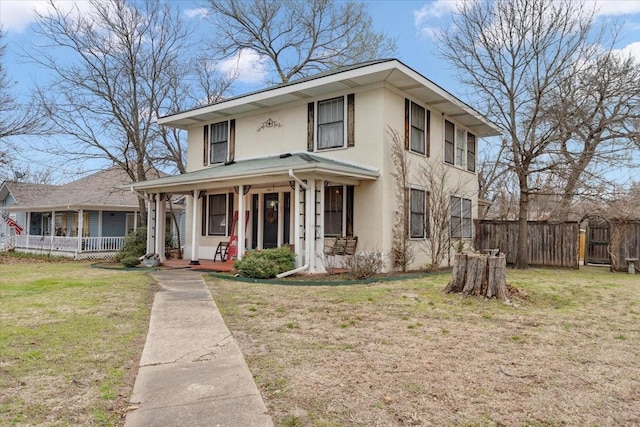 view of front of home with a front lawn, fence, covered porch, and stucco siding