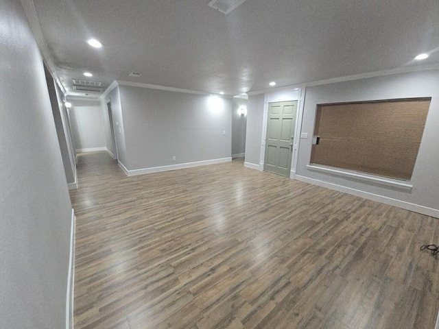 empty room featuring recessed lighting, ornamental molding, baseboards, and wood finished floors